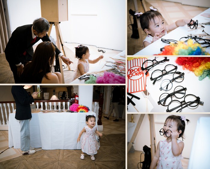 Wedding guests choosing photobooth props at a Singapore wedding at 1-Flowerhill, Sentosa