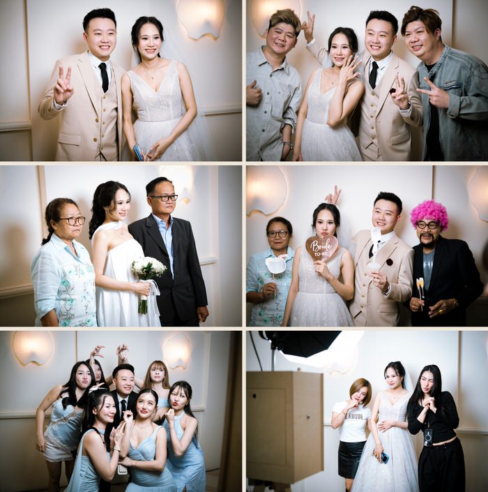 The couple with friends and family at their wedding photobooth